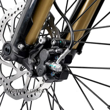 Front hydraulic brake caliper and disc on the Arctic Leopard XE Pro R, with gold fork lower and spoked wheel