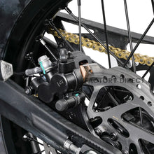 Rear hydraulic brake caliper and disc on the Arctic Leopard XE Pro R, with gold drive chain and swingarm
